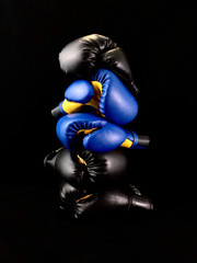 Boxing gloves on a black background. Sports accessories for boxing. Leather gloves for martial...