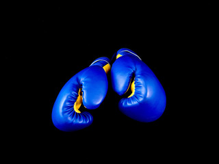Boxing gloves on a black background. Sports accessories for boxing. Leather gloves for martial...