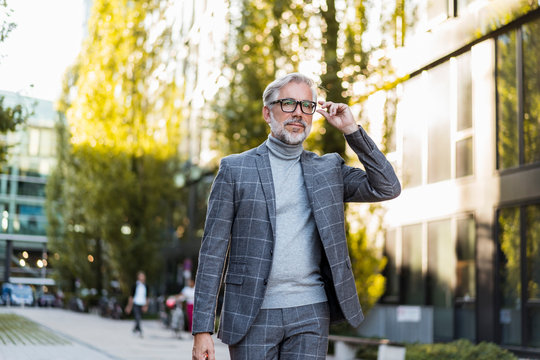 Fashionable mature, businessman on the go in the city