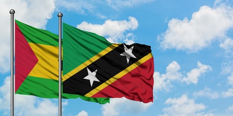 Sao Tome And Principe and Saint Kitts And Nevis flag waving in the wind against white cloudy blue sky together. Diplomacy concept, international relations.