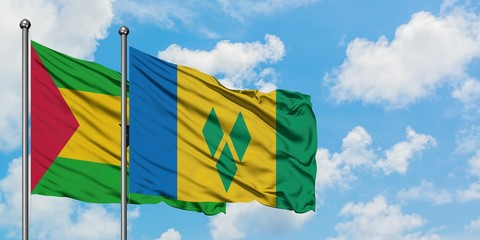 Sao Tome And Principe and Saint Vincent And The Grenadines flag waving in the wind against white cloudy blue sky together. Diplomacy concept, international relations.
