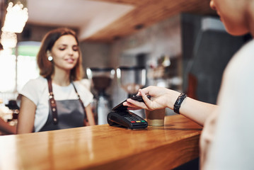 Young female cafe worker indoors. Conception of business and service