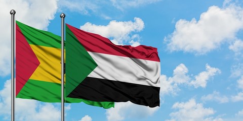 Sao Tome And Principe and Sudan flag waving in the wind against white cloudy blue sky together. Diplomacy concept, international relations.