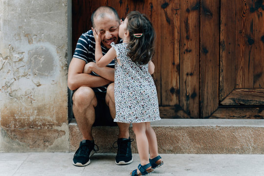 Little girl kissing her father outdoors, Mallorca, Spain