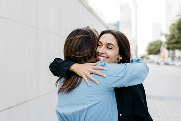 Two women hugging each other