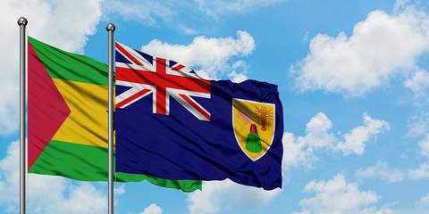 Sao Tome And Principe and Turks And Caicos Islands flag waving in the wind against white cloudy blue sky together. Diplomacy concept, international relations.