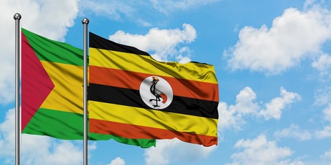 Sao Tome And Principe and Uganda flag waving in the wind against white cloudy blue sky together. Diplomacy concept, international relations.