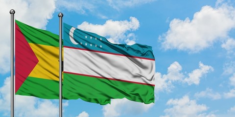 Sao Tome And Principe and Uzbekistan flag waving in the wind against white cloudy blue sky together. Diplomacy concept, international relations.