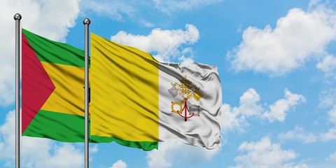 Sao Tome And Principe and Vatican City flag waving in the wind against white cloudy blue sky together. Diplomacy concept, international relations.