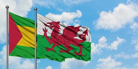 Sao Tome And Principe and Wales flag waving in the wind against white cloudy blue sky together. Diplomacy concept, international relations.