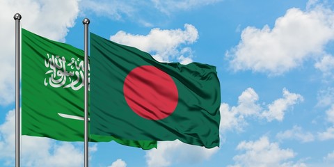 Saudi Arabia and Bangladesh flag waving in the wind against white cloudy blue sky together. Diplomacy concept, international relations.