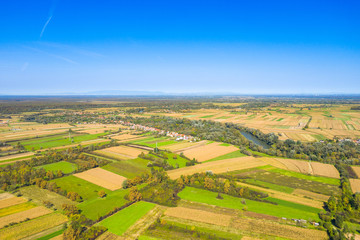 Beautiful countryside landscape in Croatia, near Sisak, Sava river meandering between agriculture fields, aerial shot from drone