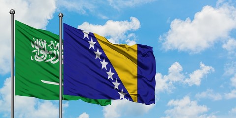 Saudi Arabia and Bosnia Herzegovina flag waving in the wind against white cloudy blue sky together. Diplomacy concept, international relations.