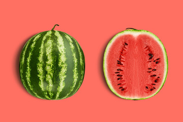 Green, striped watermelon, pink background with copy space for text, images. Cross-section. Berry with red flesh, black seeds. Top view. Close-up.