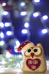 Obraz na płótnie Canvas New Year's toy owl in Christmas decorations