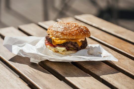 Close-up of cheeseburger on wooden table