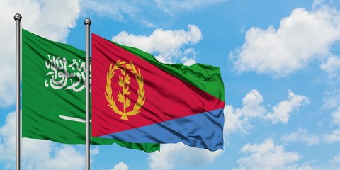 Saudi Arabia and Eritrea flag waving in the wind against white cloudy blue sky together. Diplomacy concept, international relations.