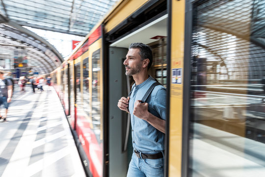 Man disembarking from train at the station platform, Berlin, Germany