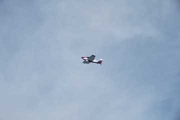 Naklejka na ściany i meble A small plane in the sky.