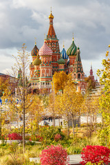 Moscow historical center in autumn. Building of Saint Basil Cathedral on Red square against golden trees and plants in sunny autumn day
