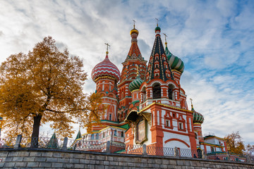 Saint Basil Cathedral on Red square in Moscow against blue sky with white clouds in sunny autumn evening. Bottom view