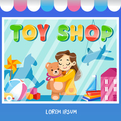 Facade toy store with a signboard, girl with teddybear, awning and playthings in shopwindow.