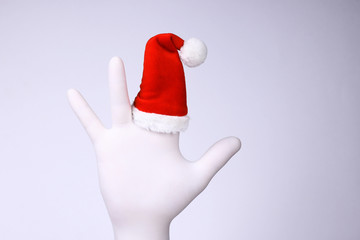 White hand with Santa Claus heat on finger. Christmas and New Year holidays concept.