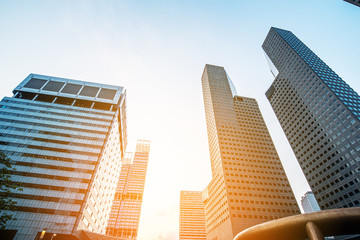 Obraz premium Modern business skyscrapers, high-rise buildings, architecture raising to the sky, sun. Concepts of financial, economics, future etc.