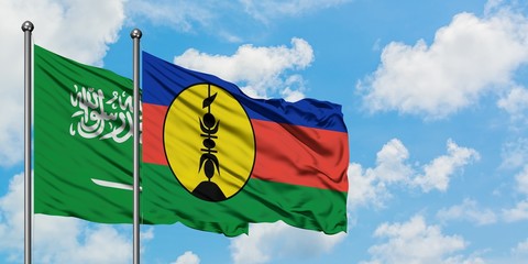 Saudi Arabia and New Caledonia flag waving in the wind against white cloudy blue sky together. Diplomacy concept, international relations.