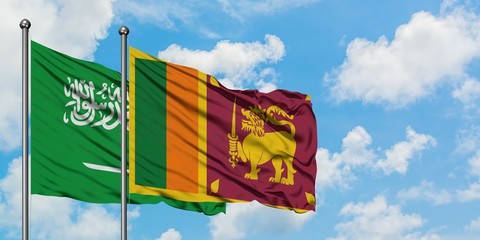 Saudi Arabia and Sri Lanka flag waving in the wind against white cloudy blue sky together....
