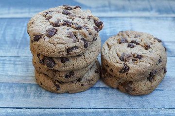 A stack of chocolate cookies on a wooden board