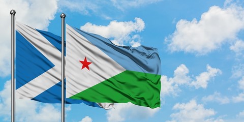 Scotland and Djibouti flag waving in the wind against white cloudy blue sky together. Diplomacy concept, international relations.