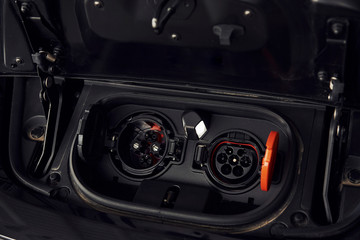 Charging inputs of brand new electrical car. Modern fuel. Conception of ecology