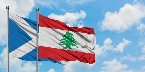 Scotland and Lebanon flag waving in the wind against white cloudy blue sky together. Diplomacy concept, international relations.