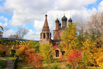 View of the old russian red brick church in Krutitsy Patriarchal Metochion surrounded by colorful autumn trees, Moscow, Russia