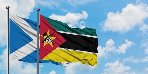 Scotland and Mozambique flag waving in the wind against white cloudy blue sky together. Diplomacy concept, international relations.