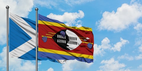 Scotland and Swaziland flag waving in the wind against white cloudy blue sky together. Diplomacy...