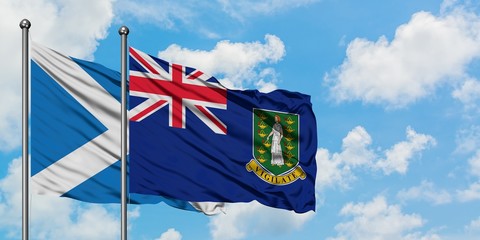 Scotland and British Virgin Islands flag waving in the wind against white cloudy blue sky together. Diplomacy concept, international relations.