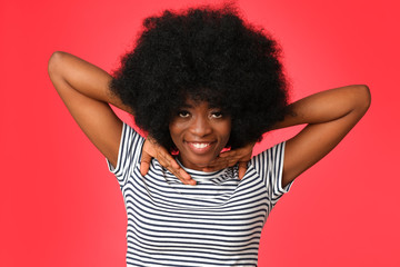 Happy afro girl in basic striped t-shirtisolated on red background. 