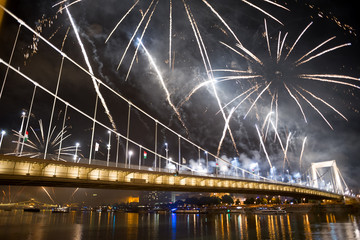 Fireworks over the bridge at night