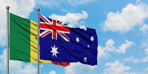 Senegal and Australia flag waving in the wind against white cloudy blue sky together. Diplomacy concept, international relations.