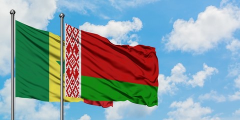 Senegal and Belarus flag waving in the wind against white cloudy blue sky together. Diplomacy...