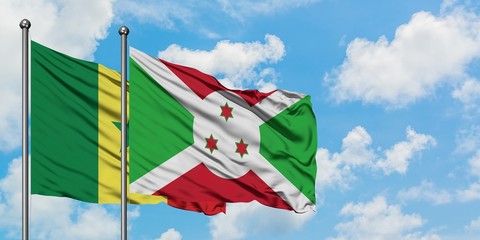 Senegal and Burundi flag waving in the wind against white cloudy blue sky together. Diplomacy...