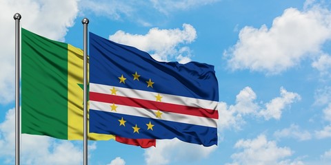 Senegal and Cape Verde flag waving in the wind against white cloudy blue sky together. Diplomacy concept, international relations.