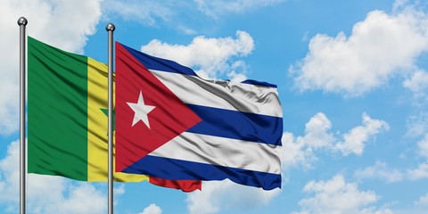 Senegal and Cuba flag waving in the wind against white cloudy blue sky together. Diplomacy concept, international relations.