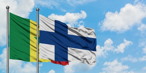 Senegal and Finland flag waving in the wind against white cloudy blue sky together. Diplomacy...