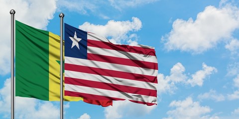Senegal and Liberia flag waving in the wind against white cloudy blue sky together. Diplomacy concept, international relations.