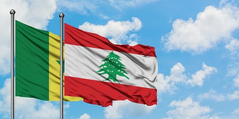 Senegal and Lebanon flag waving in the wind against white cloudy blue sky together. Diplomacy concept, international relations.