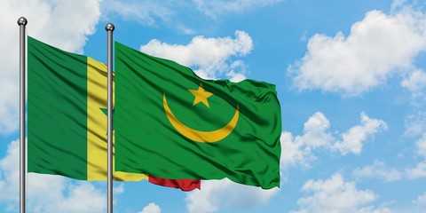 Senegal and Mauritania flag waving in the wind against white cloudy blue sky together. Diplomacy...