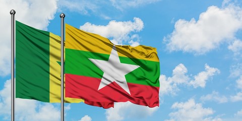 Senegal and Myanmar flag waving in the wind against white cloudy blue sky together. Diplomacy concept, international relations.
